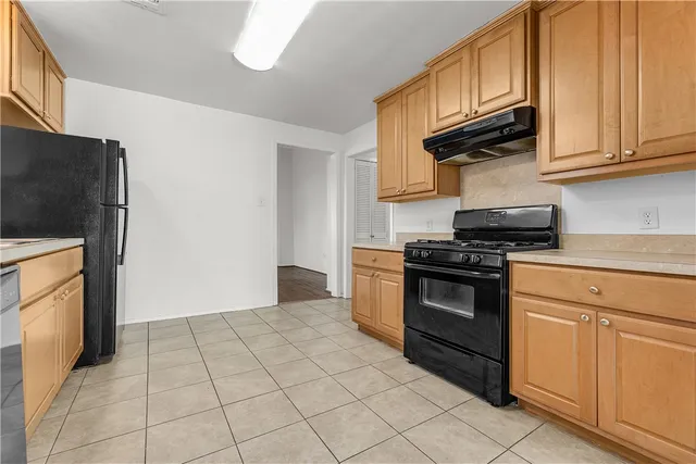 a kitchen with stainless steel appliances granite countertop a stove and a refrigerator