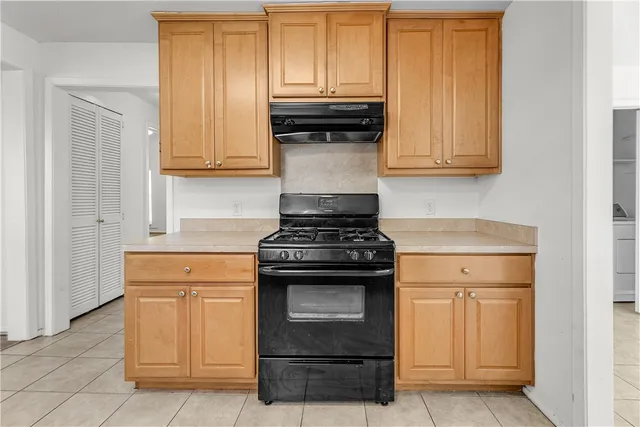 a kitchen with granite countertop white cabinets and stainless steel appliances