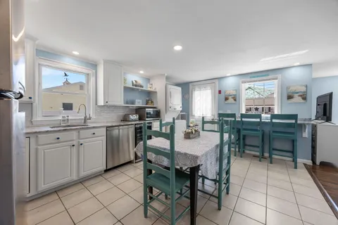 a kitchen with granite countertop cabinets and chairs