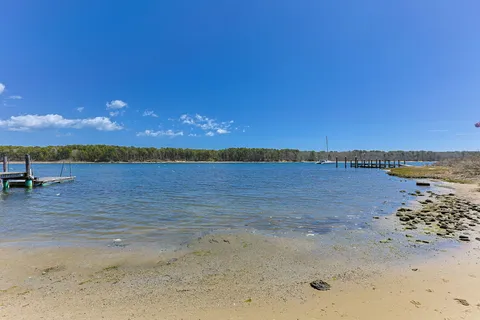 a view of a lake with beach and city view