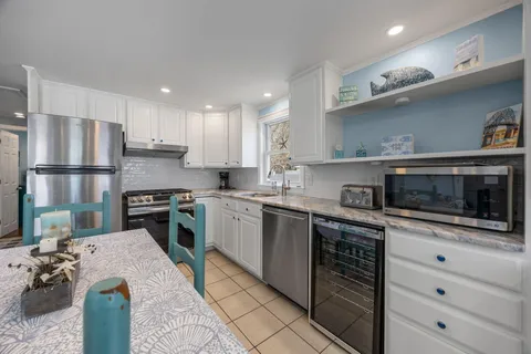 a kitchen with a sink a stove and refrigerator