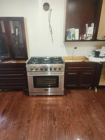 a stove top oven sitting inside of a kitchen