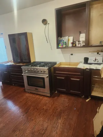 a kitchen with stainless steel appliances a stove a sink and a microwave