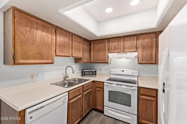 a kitchen with a stove sink and cabinets