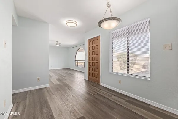 a view of a room with wooden floor and windows