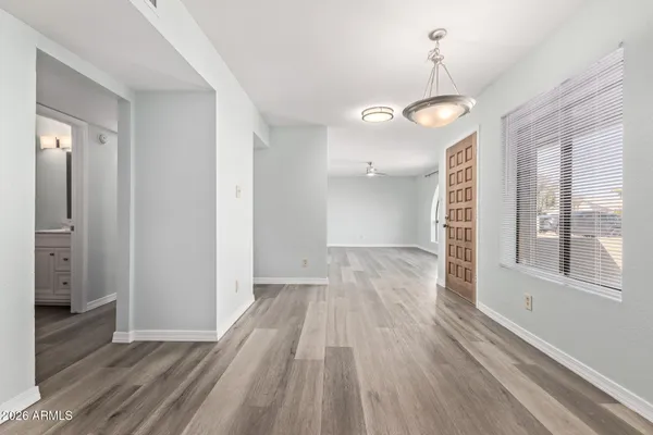 a view of a room with wooden floor and window
