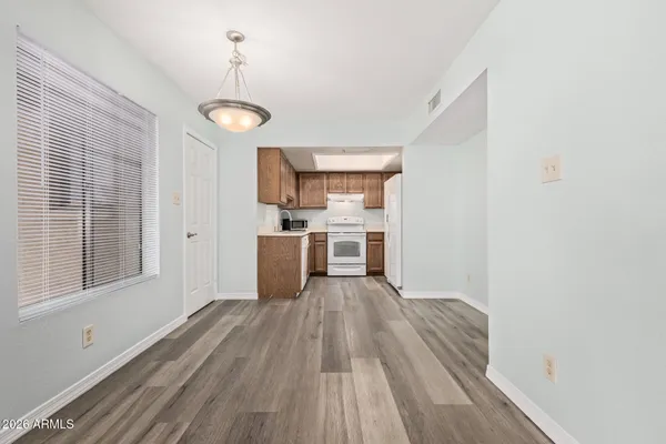 a view of a kitchen with wooden floor electronic appliances and window
