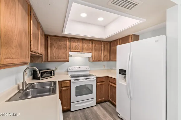 a kitchen with a stove top oven sink and cabinets