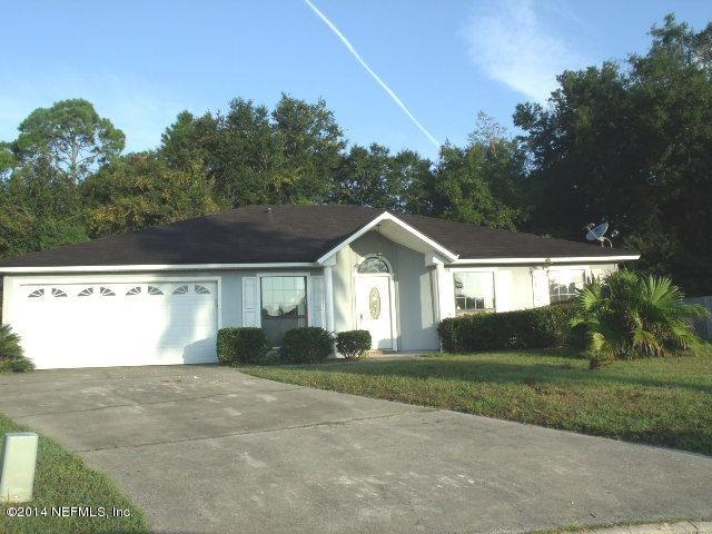 7893 Springtime Lane Jacksonville, FL 32221 - Photo 1 of 14 a front view of a house with a yard and garage
