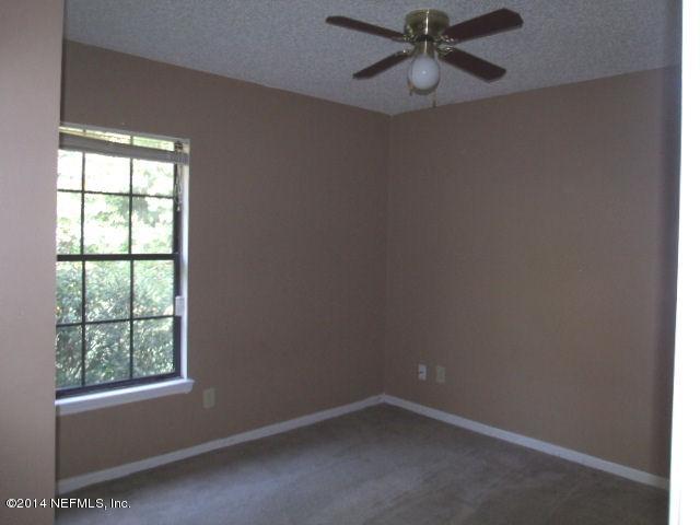 7893 Springtime Lane Jacksonville, FL 32221 - Photo 12 of 14 an empty room with windows and fan