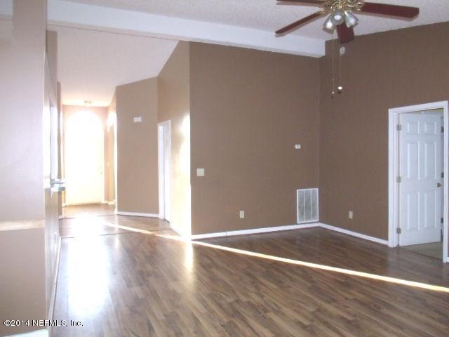 7893 Springtime Lane Jacksonville, FL 32221 - Photo 6 of 14 a view of an empty room with wooden floor and a window