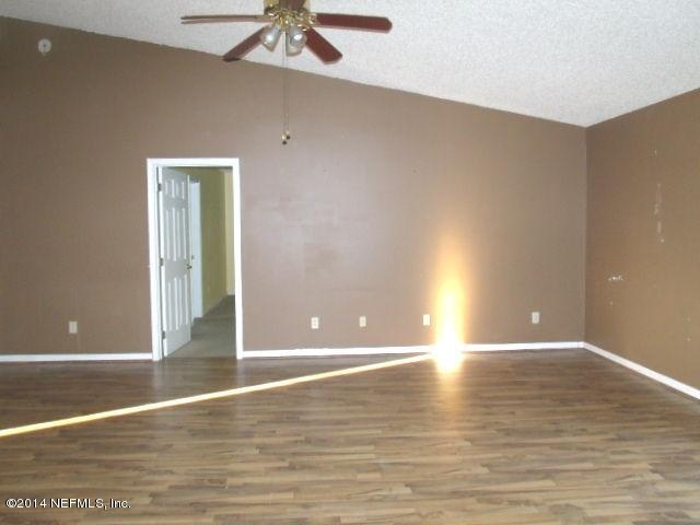 7893 Springtime Lane Jacksonville, FL 32221 - Photo 7 of 14 a view of an empty room with window and wooden floor