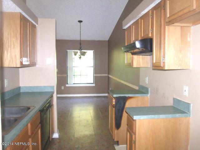 7893 Springtime Lane Jacksonville, FL 32221 - Photo 9 of 14 a kitchen with a sink a window and cabinets