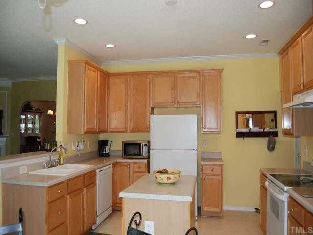 5608 Enoree Lane Raleigh, NC 27616 - Photo 4 of 12 This lovely kitchen has 422 maple cabinets, center island, neutral countertop, white double sink with disposal, dishwasher, smooth top stove, exhaust fan, 6 recessed lights, 99 ceiling and an eat in bar area overlooking the living room