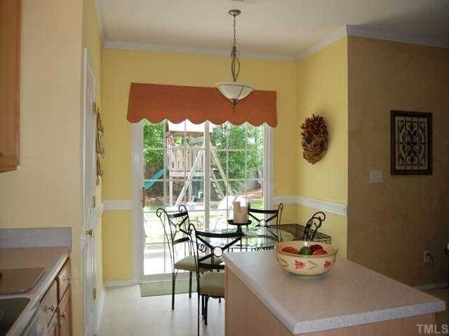 5608 Enoree Lane Raleigh, NC 27616 - Photo 5 of 12 The breakfast nook has an upgraded chandelier, pantry, painted crown molding, no wax vinyl floor, designer color wall paint, 99 ceiling and a sliding glass door to the patio