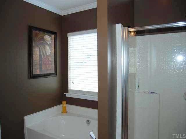 5608 Enoree Lane Raleigh, NC 27616 - Photo 8 of 12 An elegant master bath has cultured marble double sink with maple cabinets, two upgraded vanity lights, two mirrors, picture window with 22 blinds, garden tub, walk in shower, walk in closet, recessed light and a separate water closet
