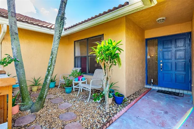 a kitchen with stainless steel appliances granite countertop a kitchen island a stove a sink a dining table and chairs