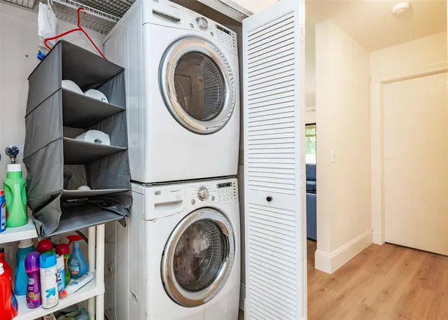 a living room with furniture a flat screen tv and a floor to ceiling window