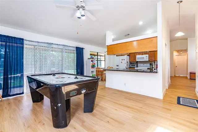a room with pool table and windows