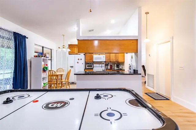 a view of a workspace with furniture and wooden floor