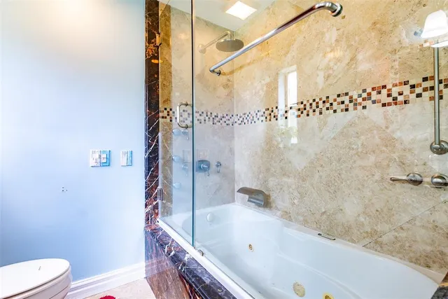 a view of a bedroom with wooden floor and chair