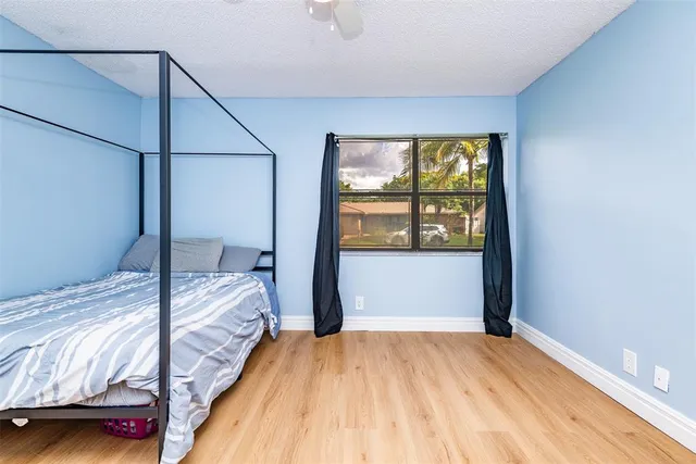 a bedroom with bed and a window