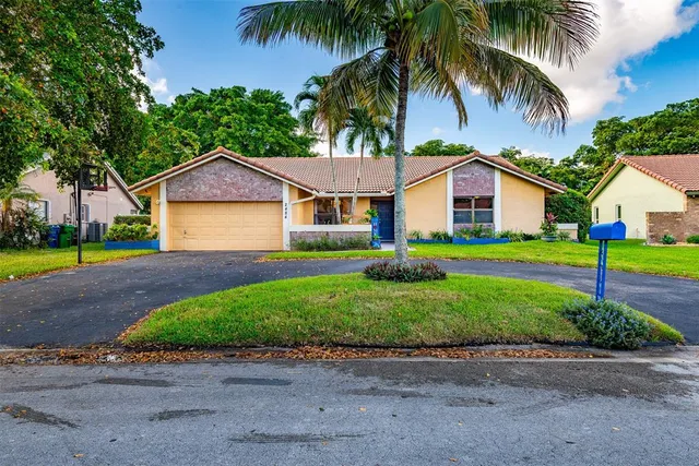 a front view of house with yard and green space