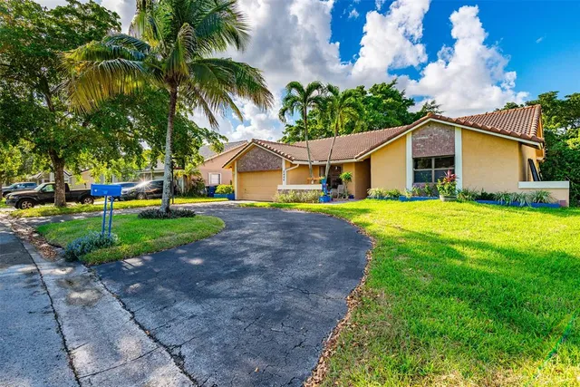 a front view of house with yard and green space
