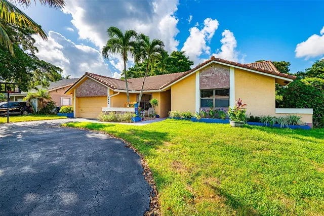 a front view of house with yard and green space