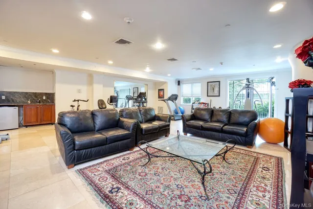 a living room with furniture a rug and a lamp