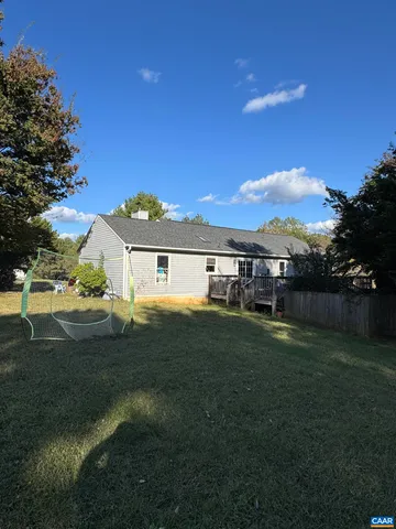 a room with a washing machine and wooden floor