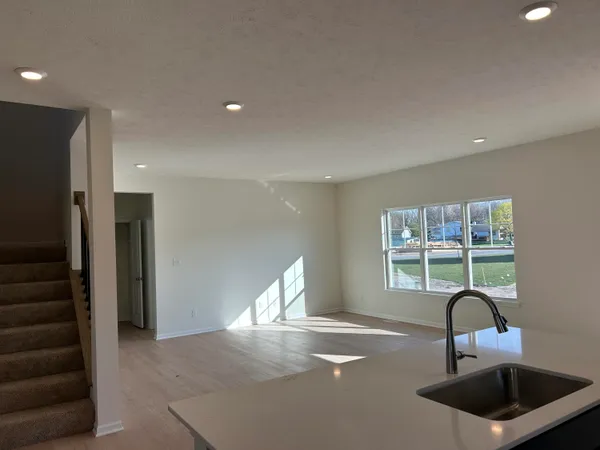 a kitchen with a sink a refrigerator and window