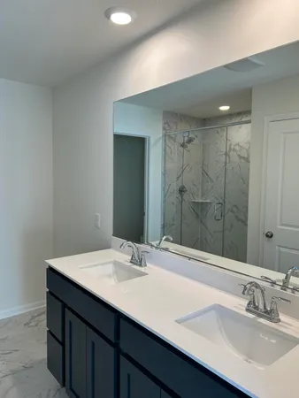 a bathroom with a sink double vanity and a mirror