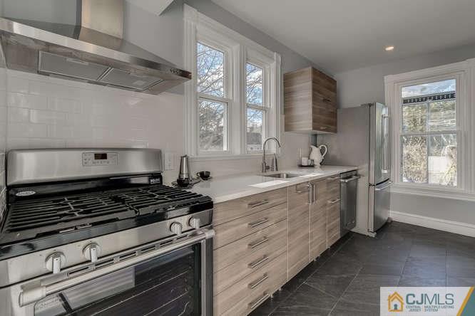 37 Wiggins Street, Unit 2 Princeton, NJ 08540 - Photo 15 of 25 a kitchen with wooden cabinets and a stove top oven