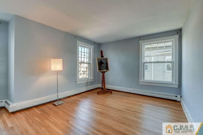 37 Wiggins Street, Unit 2 Princeton, NJ 08540 - Photo 18 of 25 an empty room with wooden floor and windows