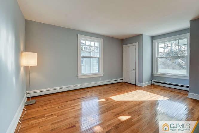 37 Wiggins Street, Unit 2 Princeton, NJ 08540 - Photo 22 of 25 an empty room with wooden floor and windows