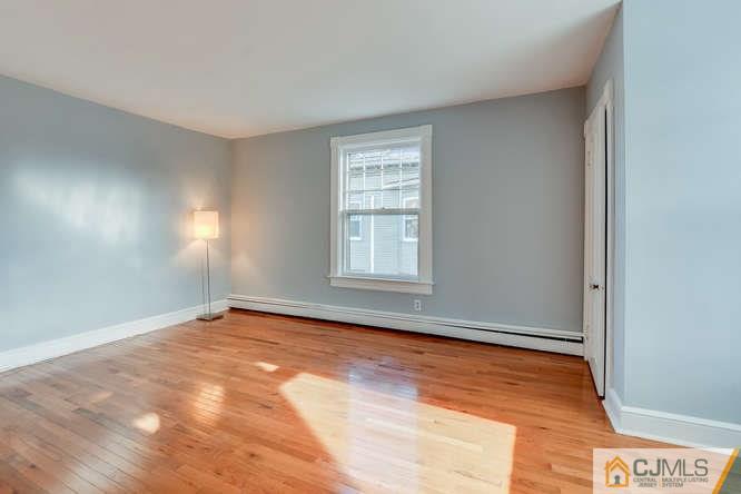 37 Wiggins Street, Unit 2 Princeton, NJ 08540 - Photo 23 of 25 a view of an empty room with wooden floor and a window