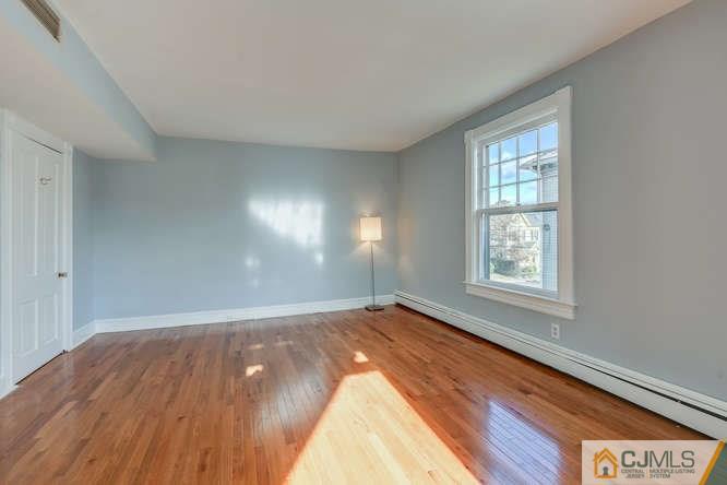 37 Wiggins Street, Unit 2 Princeton, NJ 08540 - Photo 24 of 25 an empty room with wooden floor and windows