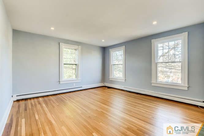 37 Wiggins Street, Unit 2 Princeton, NJ 08540 - Photo 5 of 25 an empty room with wooden floor and windows