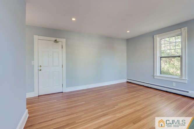37 Wiggins Street, Unit 2 Princeton, NJ 08540 - Photo 6 of 25 a view of an empty room with wooden floor and a window