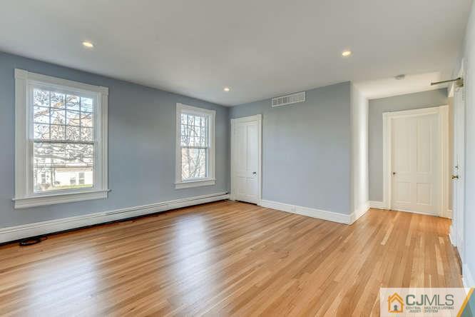 37 Wiggins Street, Unit 2 Princeton, NJ 08540 - Photo 8 of 25 a view of an empty room with wooden floor and a window