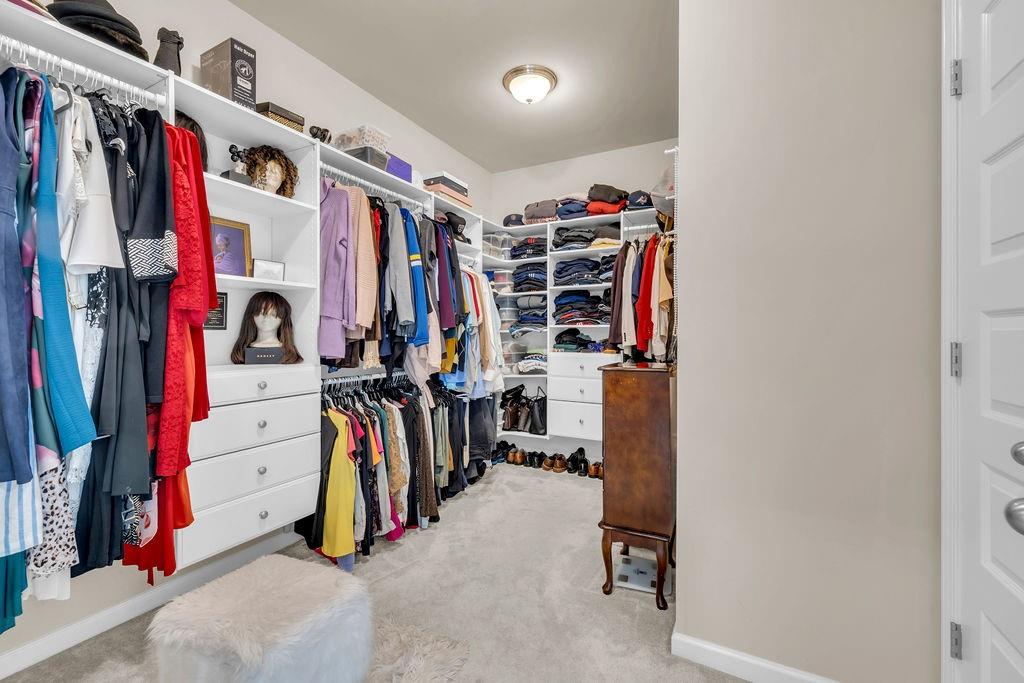 549 Harmony Way Locust Grove, GA 30248 - Photo 15 of 28 a view of walk in closet with clothes