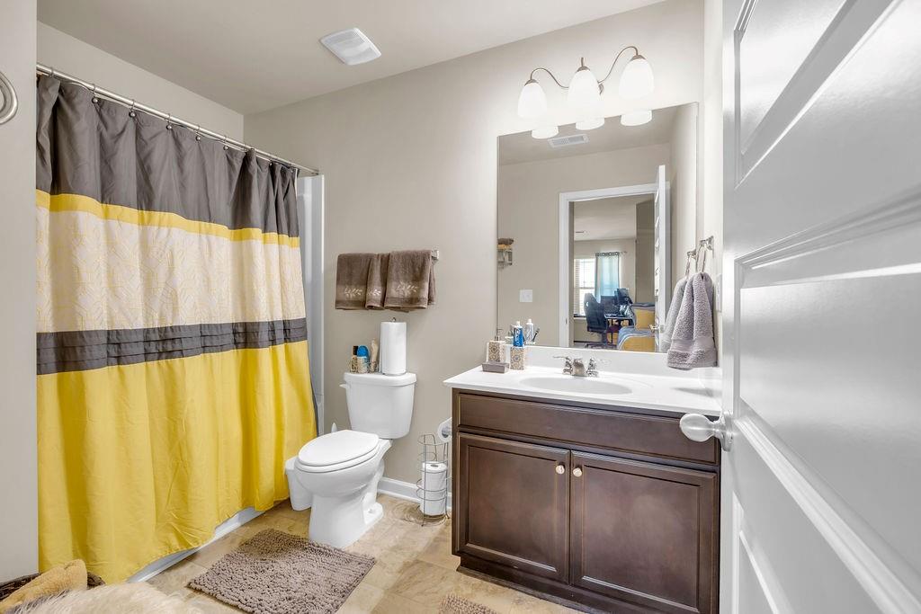 549 Harmony Way Locust Grove, GA 30248 - Photo 18 of 28 a bathroom with a sink a toilet and a mirror