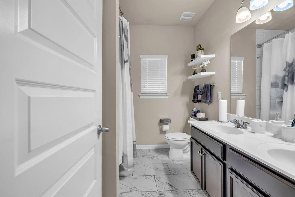 549 Harmony Way Locust Grove, GA 30248 - Photo 9 of 28 a bathroom with a sink a toilet and shower