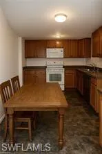 a kitchen with a table chairs sink and stove