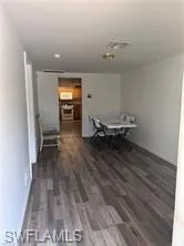 a view of a room with wooden floor and windows