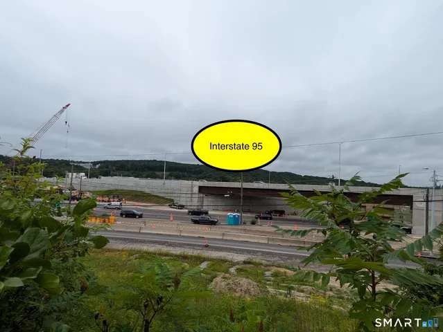a view of a field with an trees in the background
