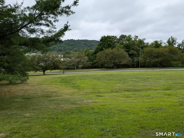 a view of a balcony with two chairs and a yard