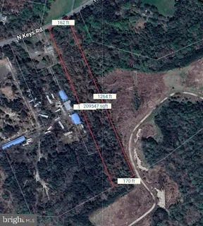 a view of a yard with wooden fence