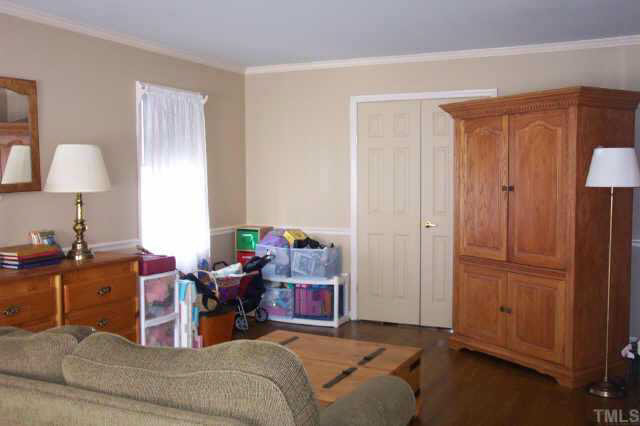 1201 Ravens Point Circle Raleigh, NC 27614 - Photo 4 of 8 a bed room with a bed and a lamp